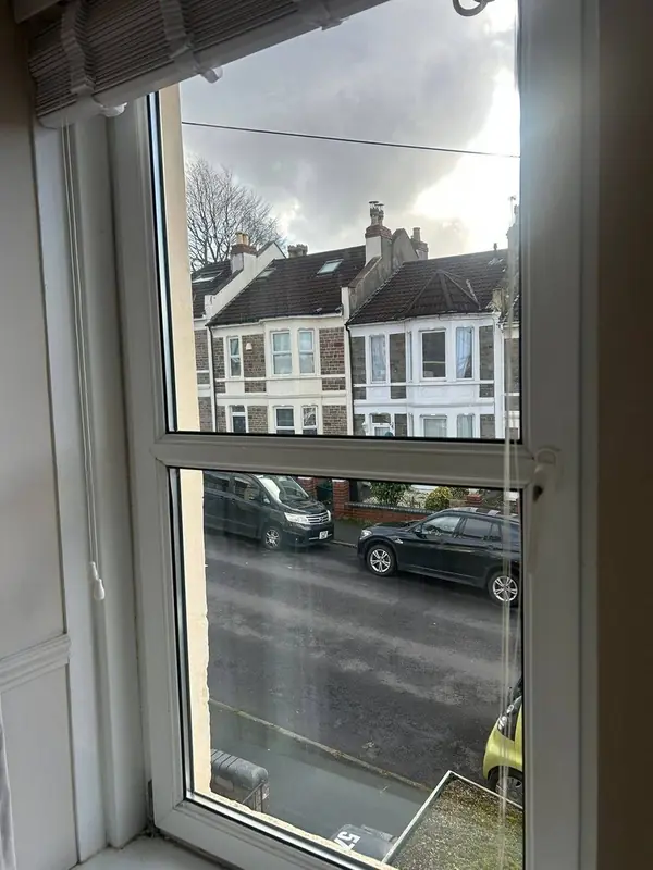 After: the same window with a new, clear sealed unit in the original frame